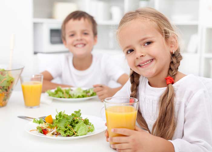 Happy Two Kids Drinking Juice