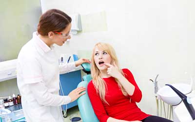 Patient Showing Her Teeth to Doctor