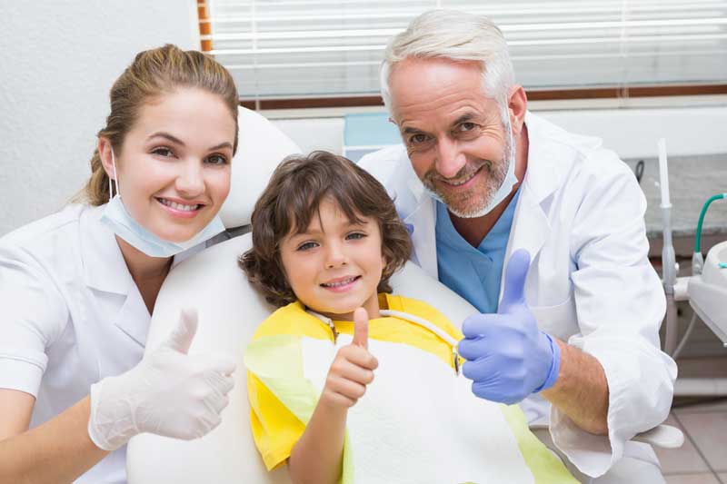 Two Dentists with Child Patient
